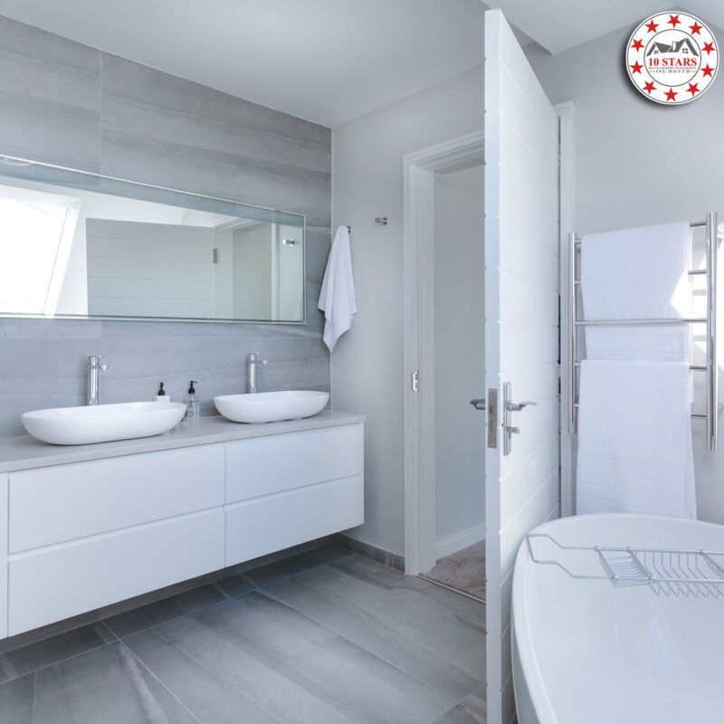 A modern bathroom with a double vanity and a bathtub